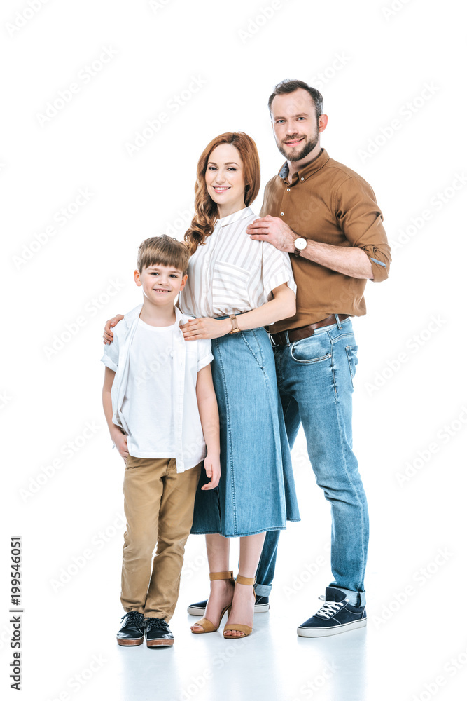 happy parents with cute little son standing together and smiling at camera isolated on white happy parents with cute little son standing together and smiling at camera isolated on white