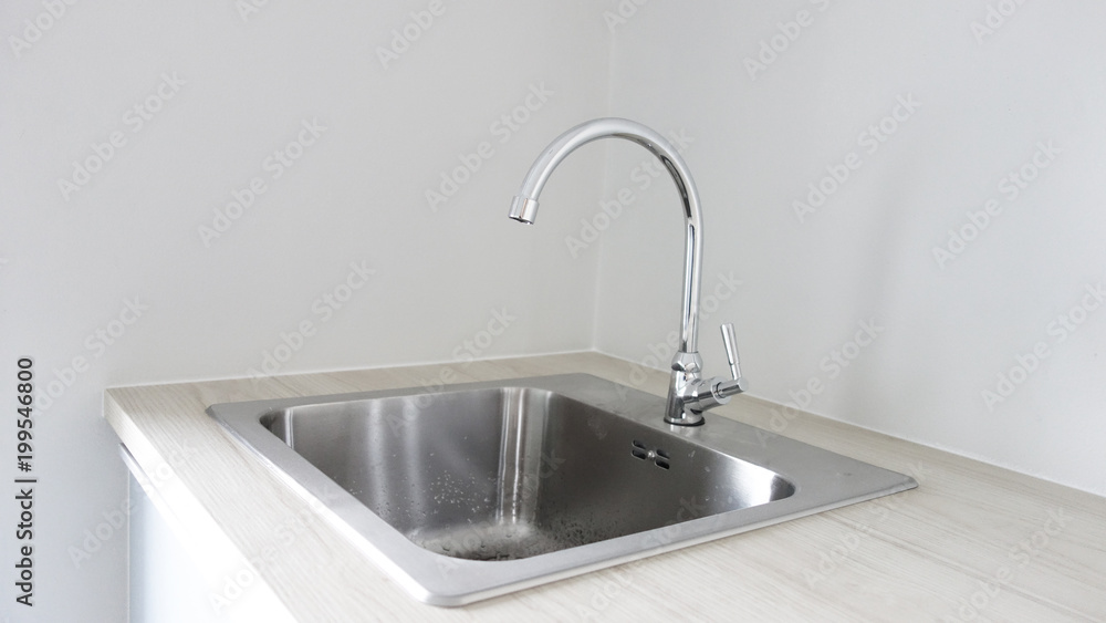stainless steel with water drop on sink. stainless steel with water drop on sink.