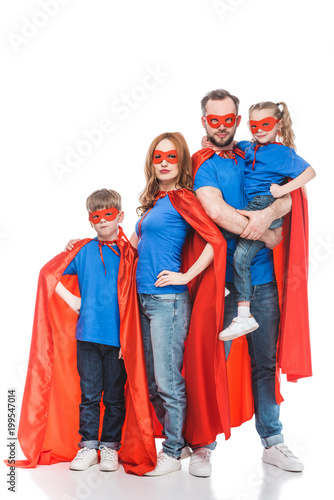 super family in masks and cloaks standing together and looking at camera isolated on white