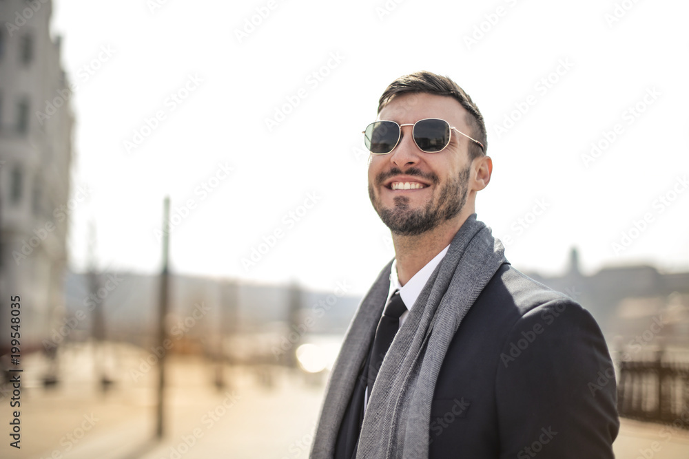 Smiling businessman wearing sunglasses Smiling businessman wearing sunglasses