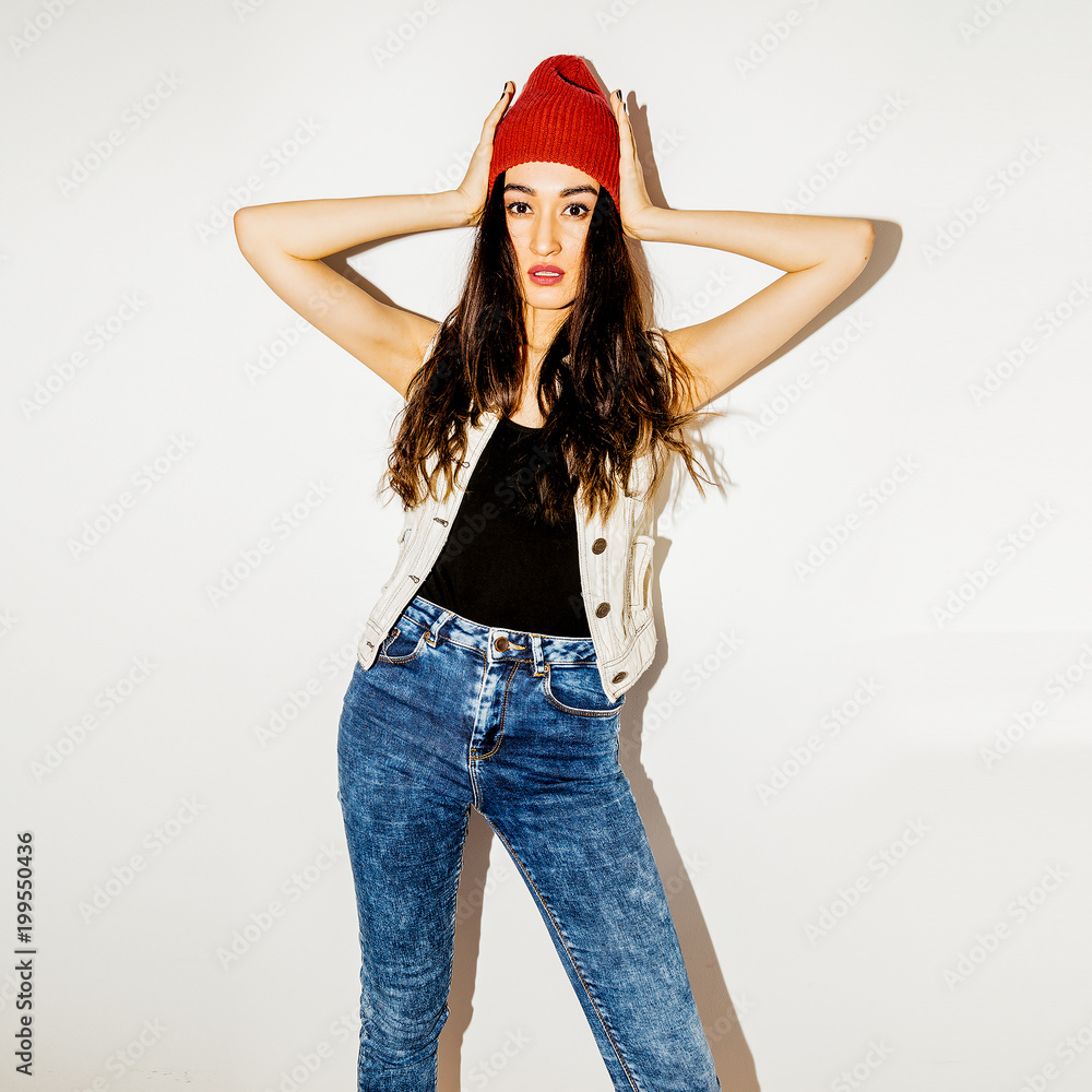 Brunette Pretty girl in fashion beanie cap and jeans. Urban casual style Brunette Pretty girl in fashion beanie cap and jeans. Urban casual style
