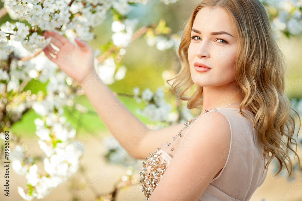Spring. Close-up horizontal portrait of a beautiful girl near blooming tree. Artwork. Copy space Spring. Close-up horizontal portrait of a beautiful girl near blooming tree. Artwork. Copy space