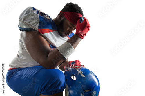 Isolated Black American football player in white background