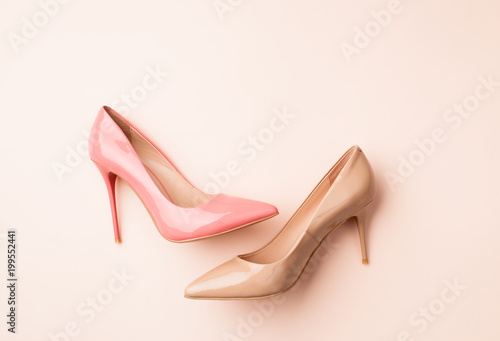 Set of colored women's shoes on pink background