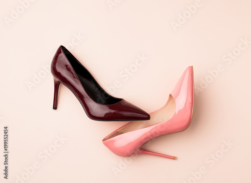Set of colored women's shoes on pink background
