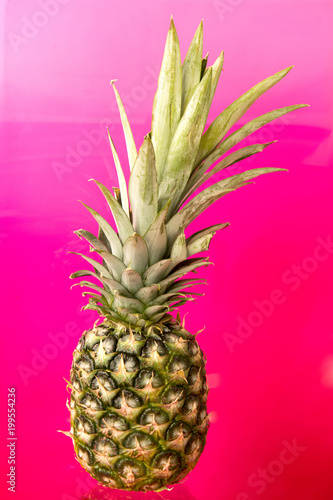 Pineapple isolated on bright neon pink background