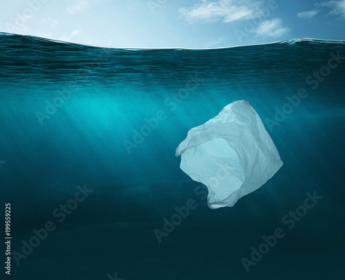 Pollution concept. Plastic bag in the ocean with copy space