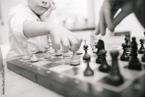Child playing chess, shallow depth of field and monochrome