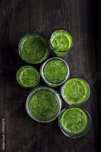 Green spinach smoothie in jars