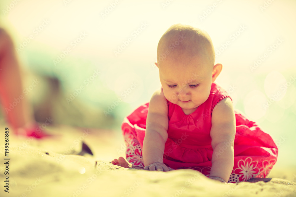 Little baby sitting and playing on beach Little baby sitting and playing on beach