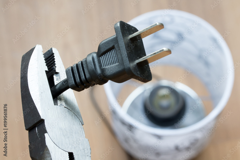 Repair of electrical cable. The pliers cut the power cord, close up view.  Stock Photo | Adobe Stock