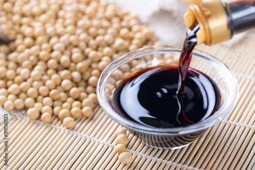 Close up of pouring soy sauce in glass bowl