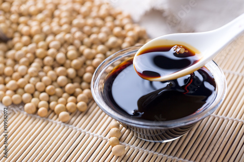 Pouring soy sauce into a glass bowl