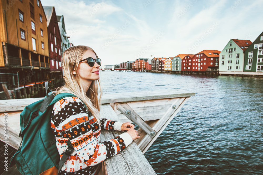 Young blonde woman traveling in Trondheim city Norway vacations weekend  Lifestyle outdoor girl tourist with backpack sightseeing scandinavian  architecture alone Stock Photo | Adobe Stock