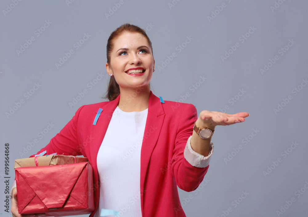Beautiful happy woman with gift box at celebration party with confetti . Birthday or New Year eve celebrating concept Beautiful happy woman with gift box at celebration party with confetti . Birthday or New Year eve celebrating concept