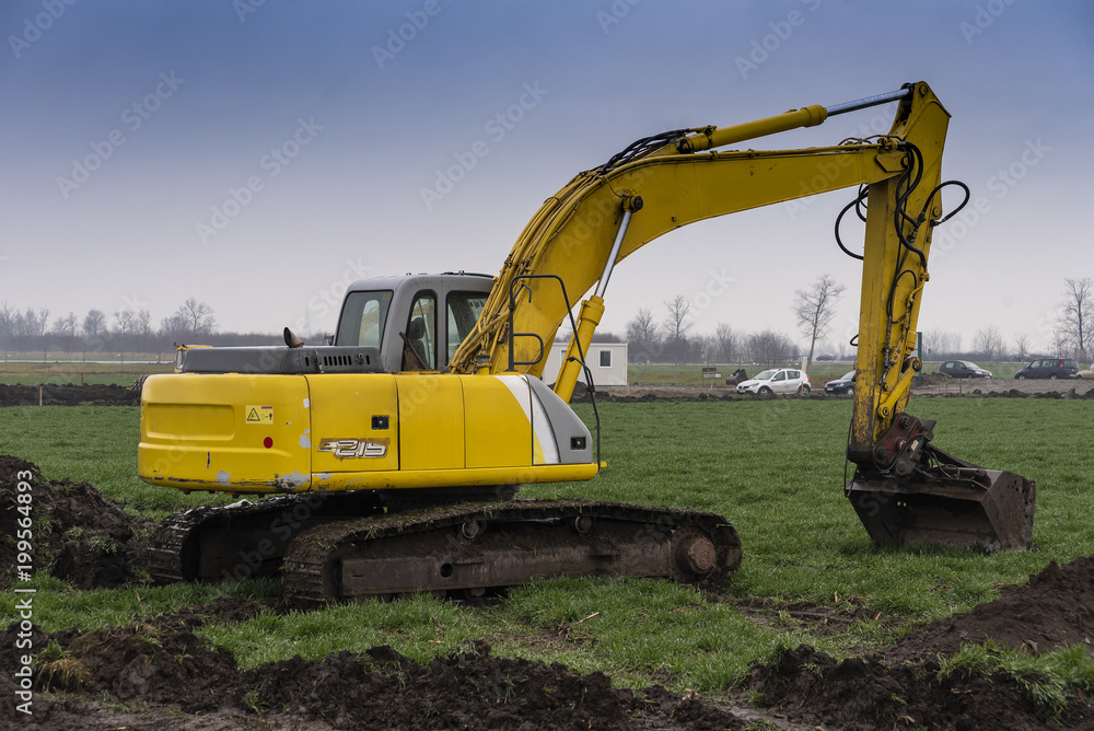 Excavators and bulldozers preparing the ground for the construction of a factory Excavators and bulldozers preparing the ground for the construction of a factory