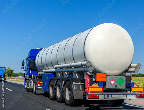 Large automotive fuel tanker truck driving on highway. Fuel transportation