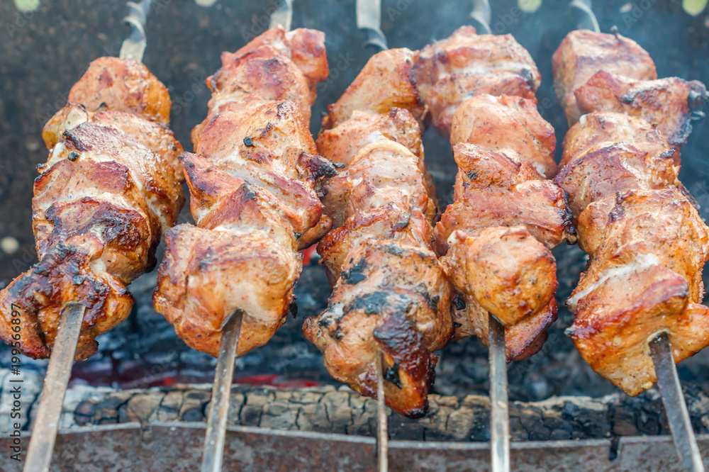 closeup of grilled meat on bbq outdoors.