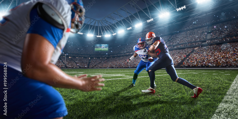 Naklejka premium American football players preforms an action play in professional sport stadium