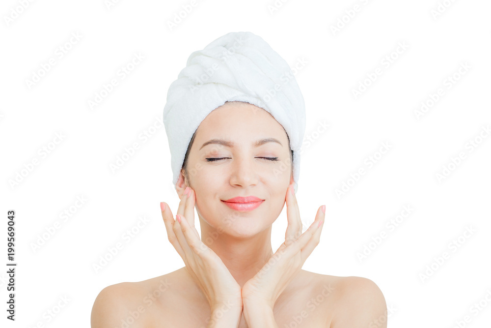 Portrait of beautiful woman smiling touching face with a towel on her head on white background with clipping path Portrait of beautiful woman smiling touching face with a towel on her head on white background with clipping path
