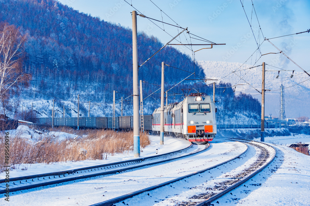 Naklejka premium Freight train moves along Baikal lake.