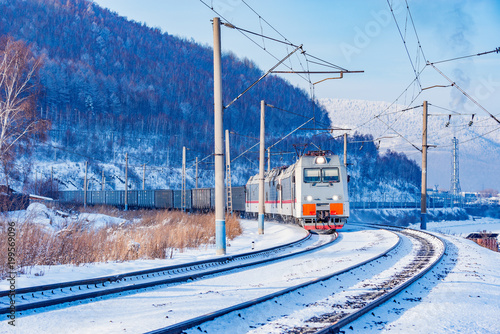 Freight train moves along Baikal lake.
