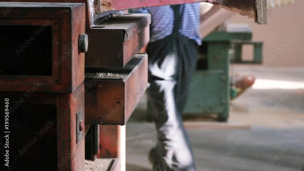grinding of wooden boards in the factory by a machine tool. Sawmill. grinding of wooden boards in the factory by a machine tool. Sawmill.