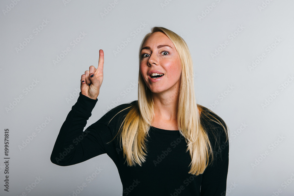 Joyful, a very happy women.Winner celebrates. Great success. Handsome young woman in black with arms up at studio. Emotion Joyful, a very happy women.Winner celebrates. Great success. Handsome young woman in black with arms up at studio. Emotion