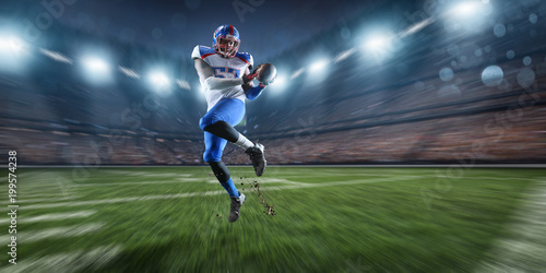 American football player performs an action play on professional sport stadium