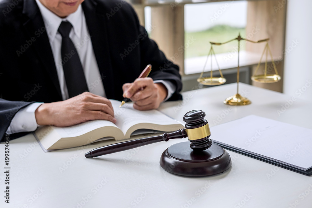 Judge gavel with Justice lawyers, Businessman in suit or lawyer working on a documents. Legal law, advice and justice concept Judge gavel with Justice lawyers, Businessman in suit or lawyer working on a documents. Legal law, advice and justice concept