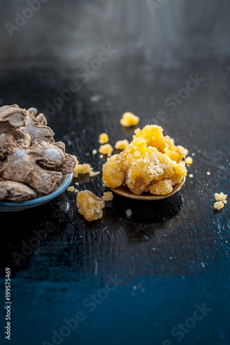 Dried ginger and jiggery a ayurvedic treatment to reduce the chances of cancer, ulcers, and diabetes its ingredients on wooden surface. photo