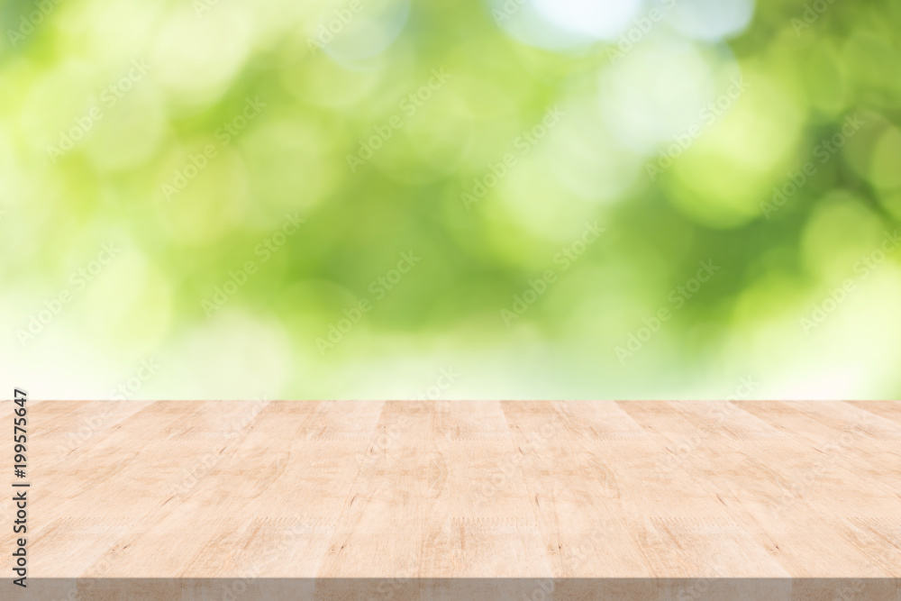 Empty wood table on blurred background copy space for montage your product or design , Blank brown board with abstract blurred green background. Empty wood table on blurred background copy space for montage your product or design , Blank brown board with abstract blurred green background.