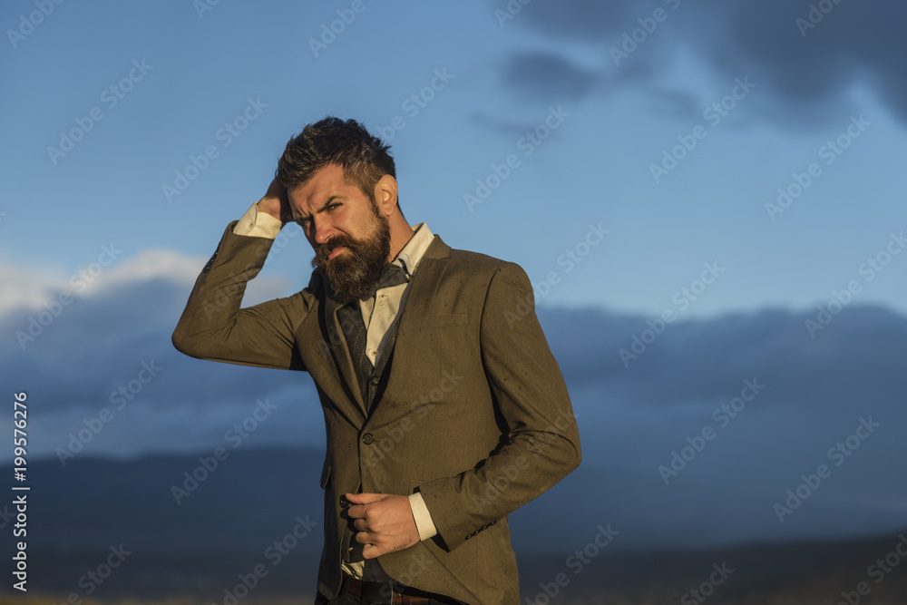 Hipster with stylish appearance in front of dramatic sky, skyline. Hipster with stylish appearance in front of dramatic sky, skyline.