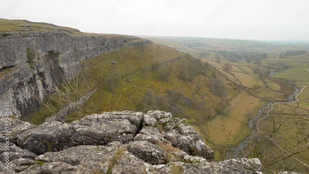 A panning shot from the top of Malham Cove in the Yorkshire Dales, England, UK. A panning shot from the top of Malham Cove in the Yorkshire Dales, England, UK.