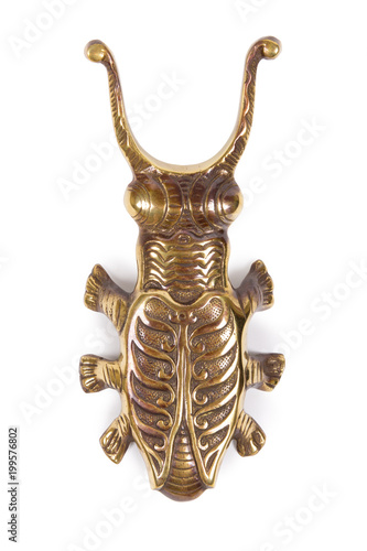 Ancient statuette of bronze beetle on white background