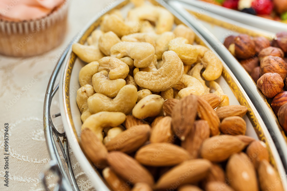 bowl with mixed nuts such as almonds, hazelnuts and cashews. Healthy food and snack bowl with mixed nuts such as almonds, hazelnuts and cashews. Healthy food and snack