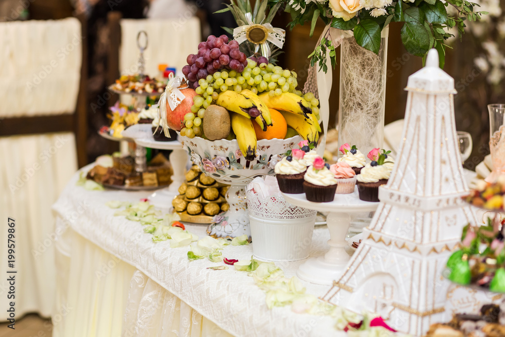 candy bar decorated by delicious sweet buffet with cupcakes and other desserts/candies,happy birthday concept