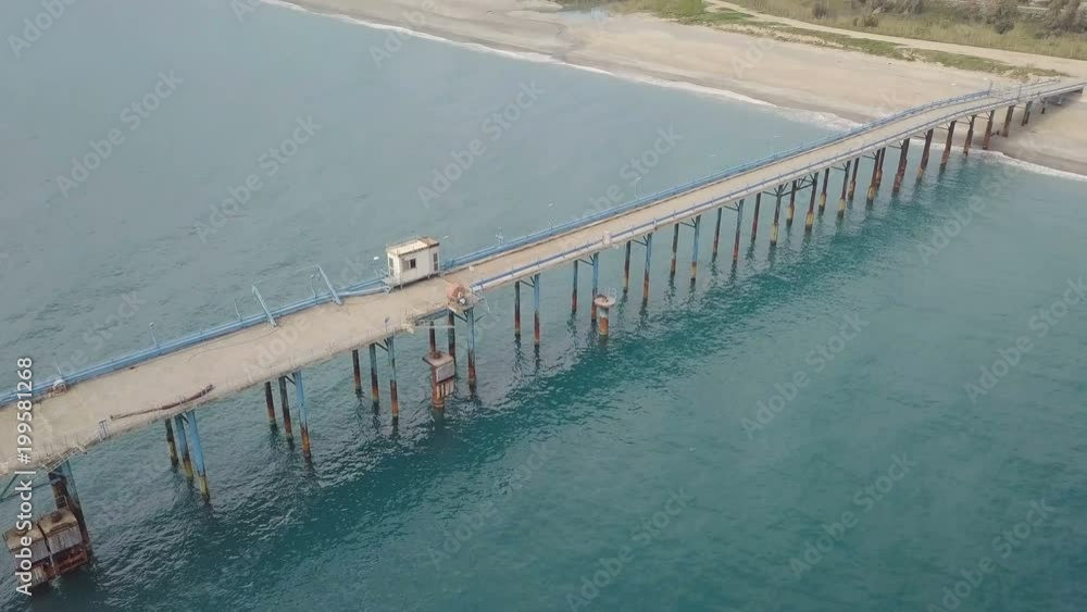 Pontile in mare con tubi per cemento e ormeggi per l'attracco delle navi Pontile in mare con tubi per cemento e ormeggi per l'attracco delle navi