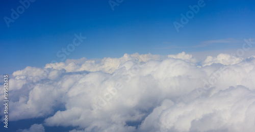 Clouds on bright blue sky backgound, plane window view © Rawf8