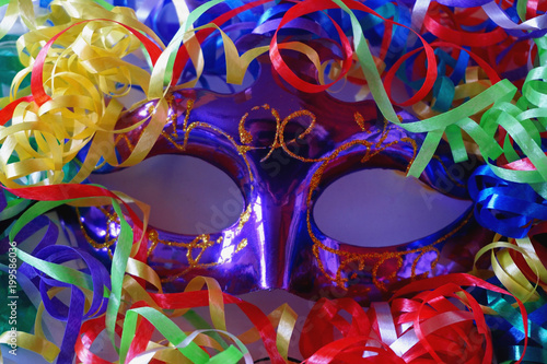 Anonymous violet carnaval mack with spripes, ribbons, confetti, tinsel.  photo