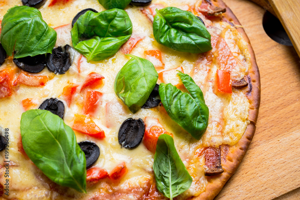 Fresh pizza served on wooden table. Selective focus. Fresh pizza served on wooden table. Selective focus.