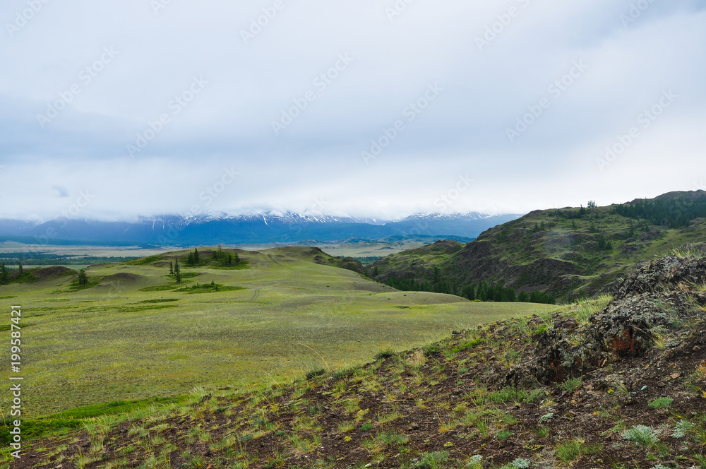Altai mountains landscape. The mountain range behind the steppe and hills