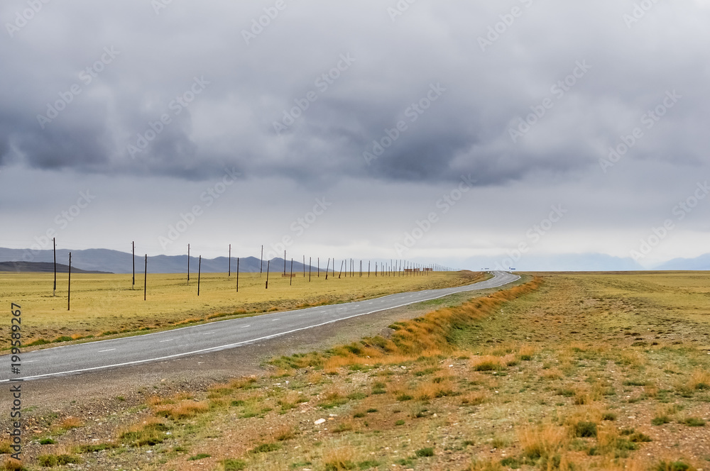 The road in the steppe. Altai Mountains The road in the steppe. Altai Mountains