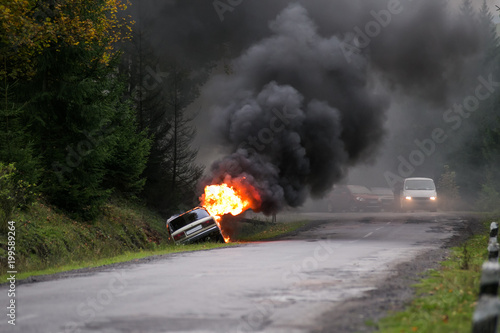 Car burning on road