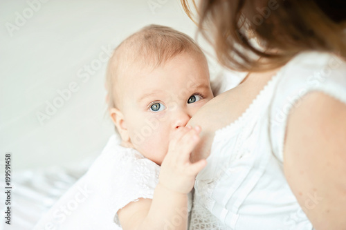 Baby eating mother's milk. Mother breastfeeding baby.