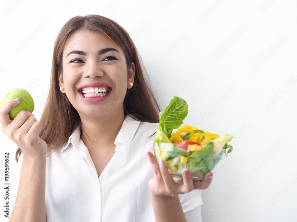 Beautiful Asian woman joyful with fresh salad in bowl. Beautiful Asian woman joyful with fresh salad in bowl.