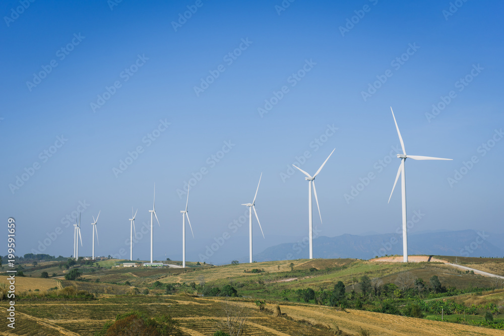 Wind turbine farm with blue sky and hill in Phetchabun, Thailand.