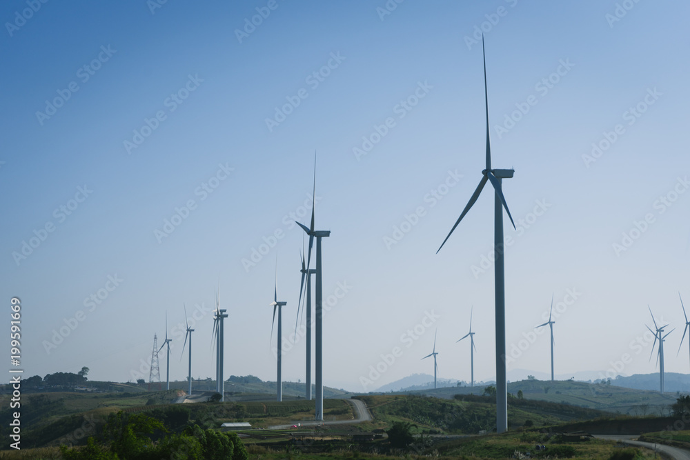 Wind turbine farm with blue sky and hill in Phetchabun, Thailand.