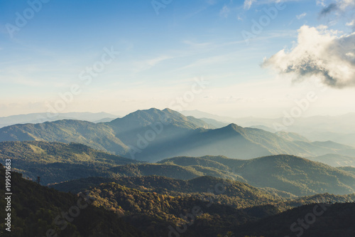 Obraz na płótnie Smoky mountain landscape with mountain and light rays before sunset. w salonie