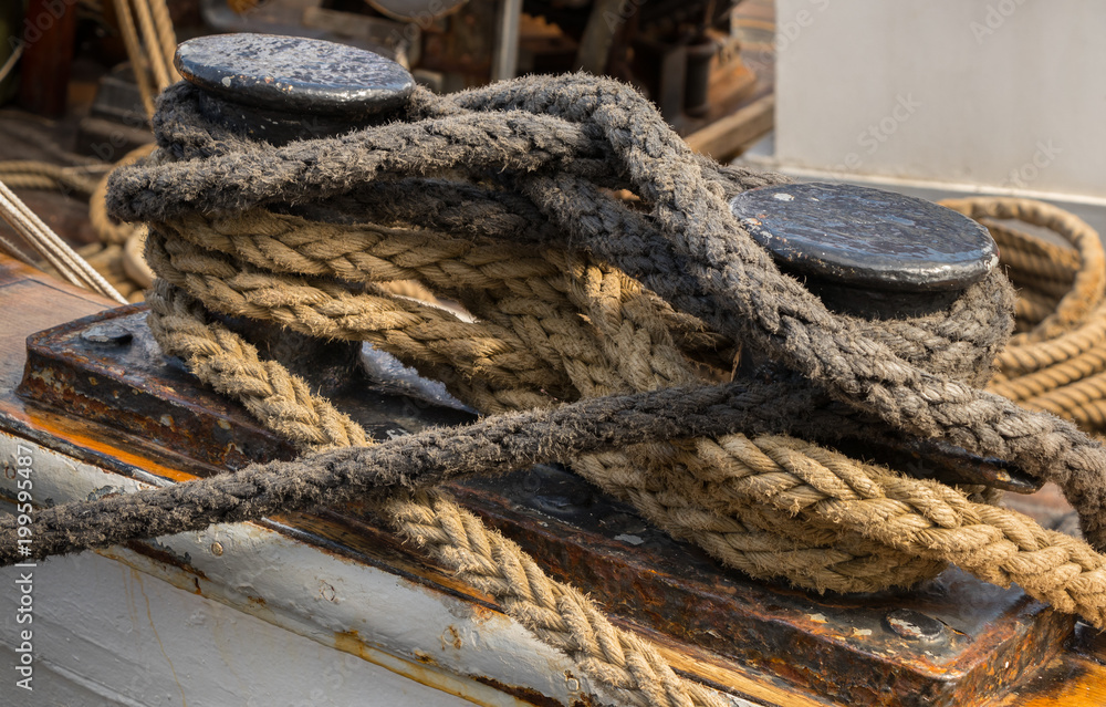 Close-up nautical knot rope tied around stake on ship